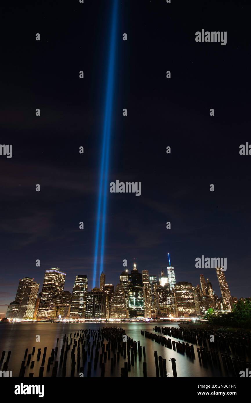 Every year on the 9/11 New York City celebrates he victims of the Twin Towers switching on two streams of blue lights. The tribute in light. Stock Photo
