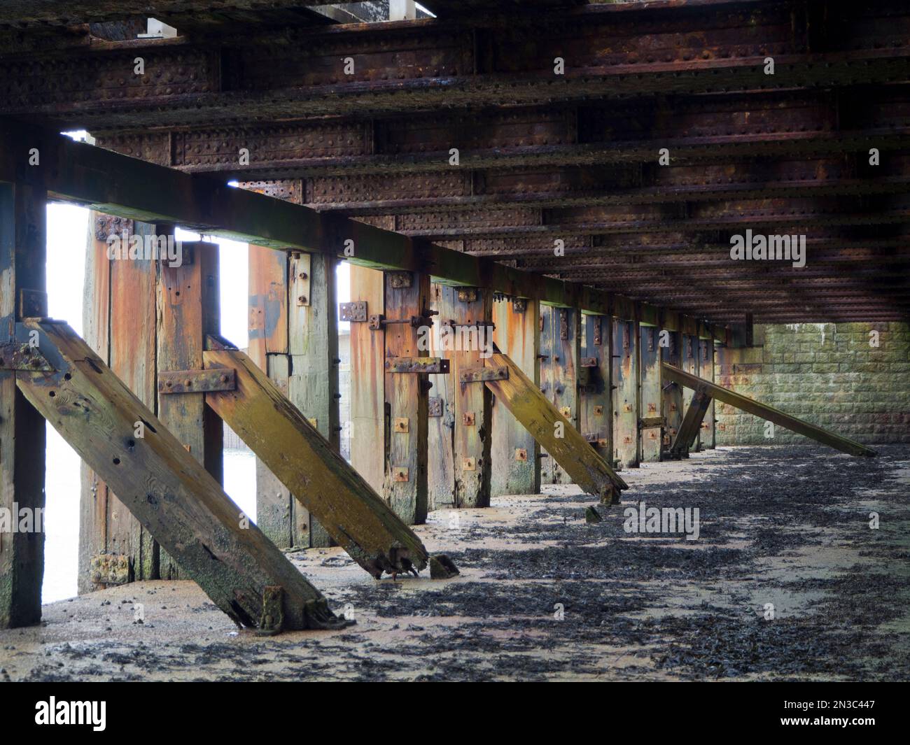 View of wooden support structure under the pier at Folkestone Harbour Arm; Folkestone, Kent, England, United Kingdom Stock Photo