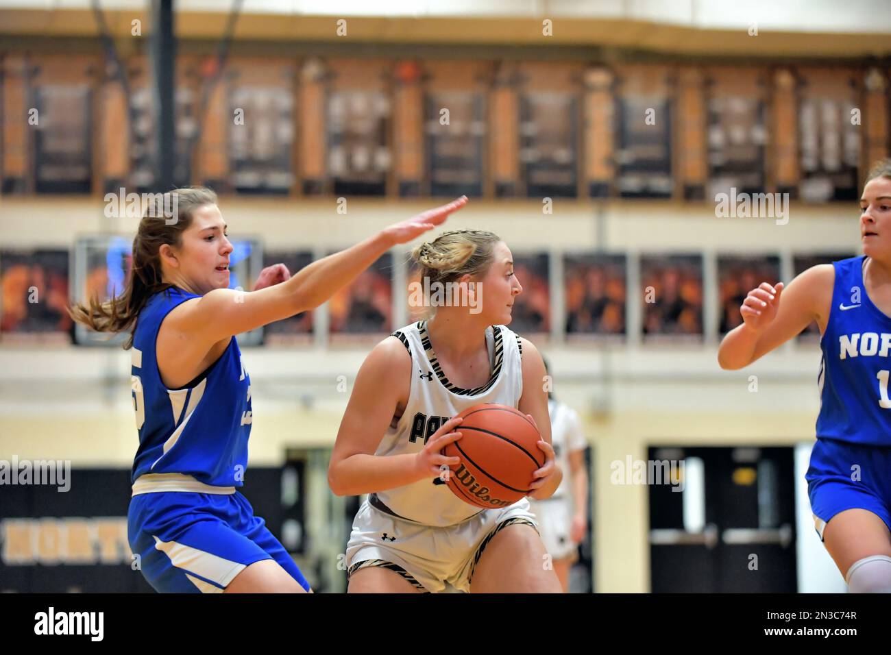 USA. Near the baseline and under the hoop, a player looks for an outlet pass opportunity. Stock Photo