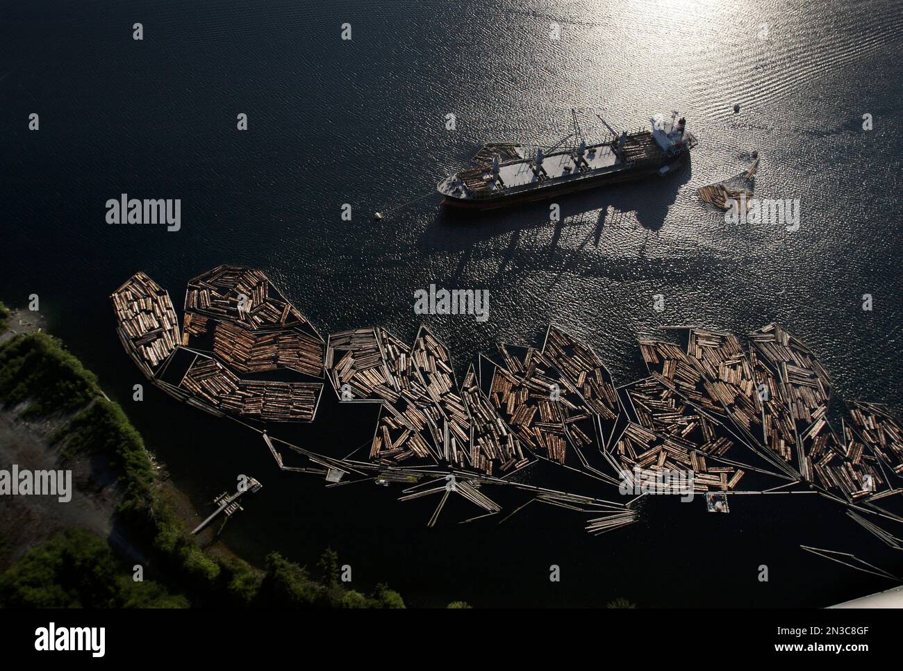 Timber is loaded for export onto a ship in protected waters in Thorne Bay on South Prince of Wales Island. The forest industry depends on overseas ... Stock Photo