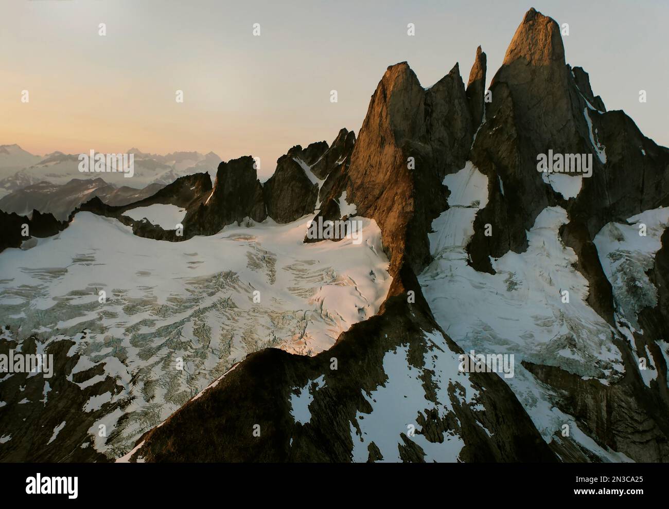 Devils Thumb stands distinctively higher than other granite peaks in Stikine Icefield. Cloaked with hanging glaciers, it's name is Taalkhunaxhkʼu S... Stock Photo