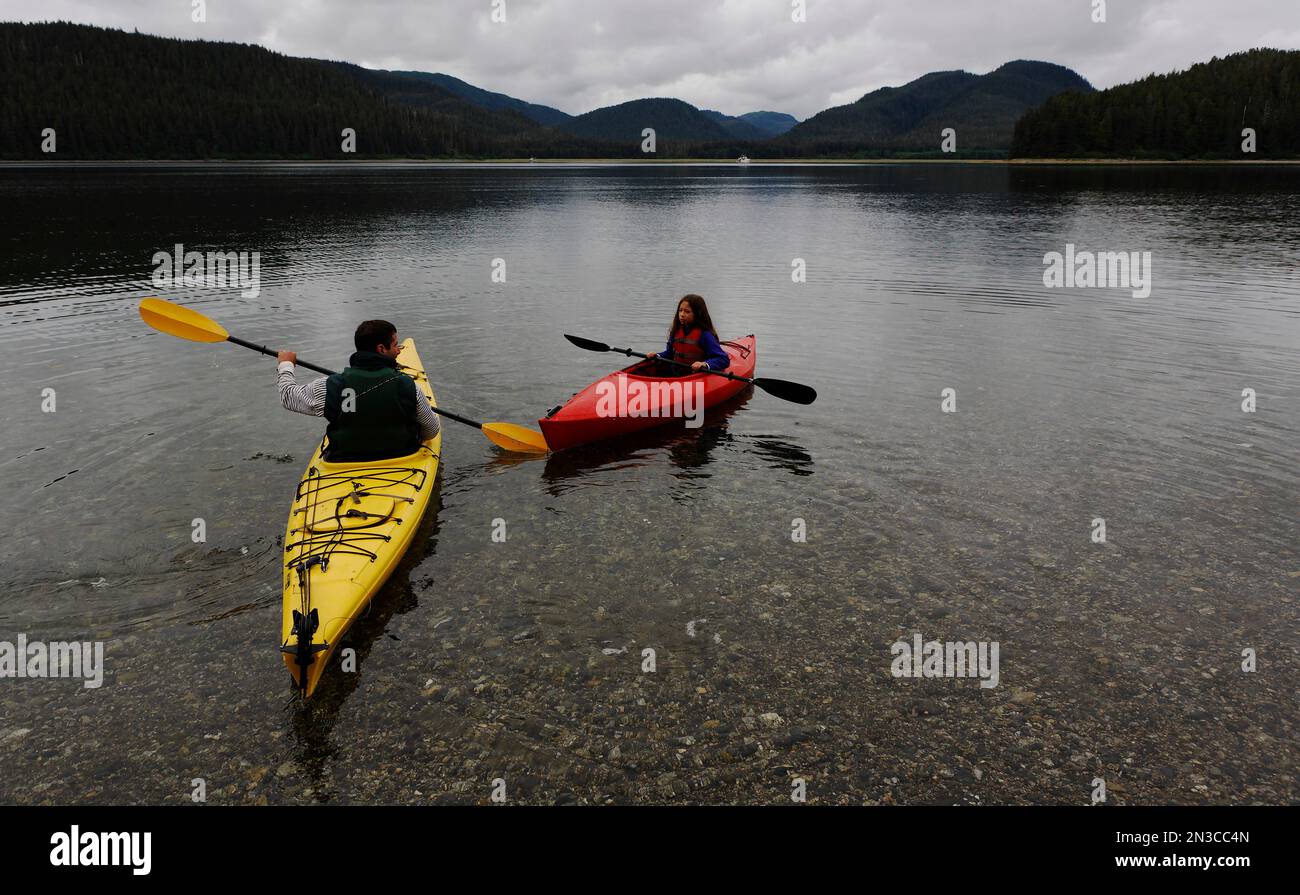 Father and daugter kayak on still water near Moser Island which