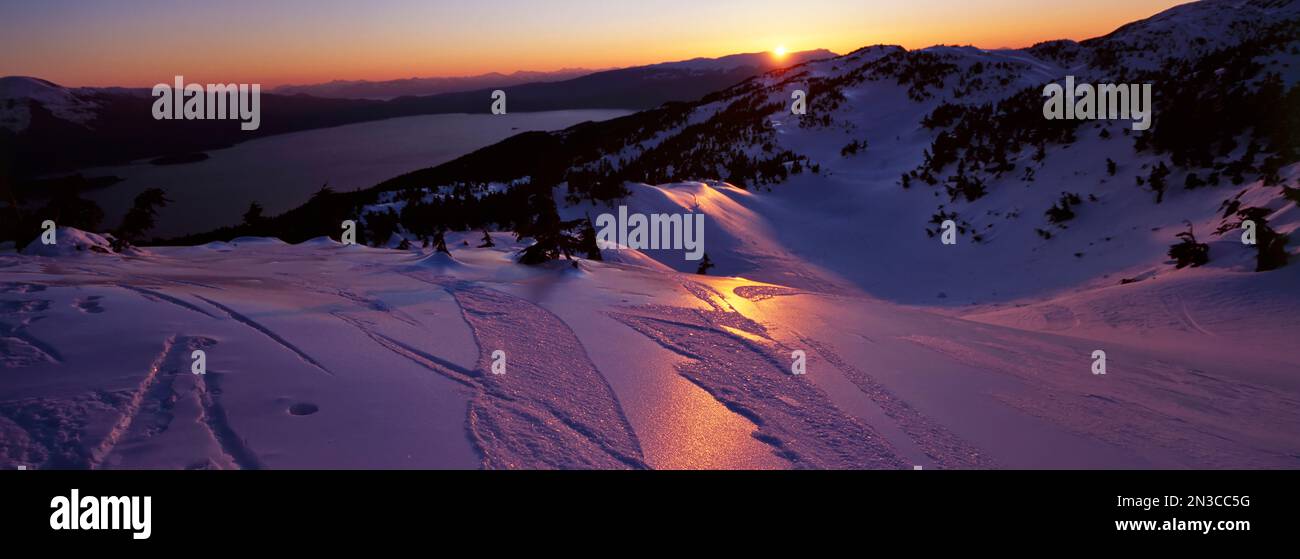 The Taku winds blow icy ridges that overlook the Inside Passage. Stillness is only broken by the sound of skiers breaking through crusty snow to vi... Stock Photo