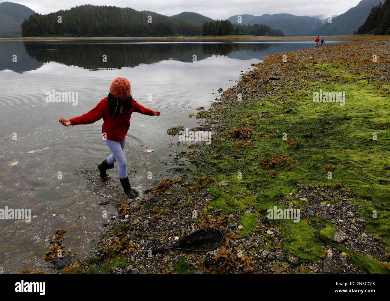 A young girl investigates sea life at low tide on Moser Island in