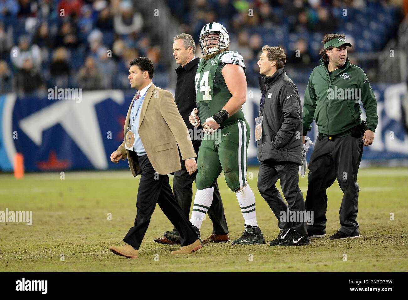 New York Jets center Nick Mangold (74) is tended to in the second half ...