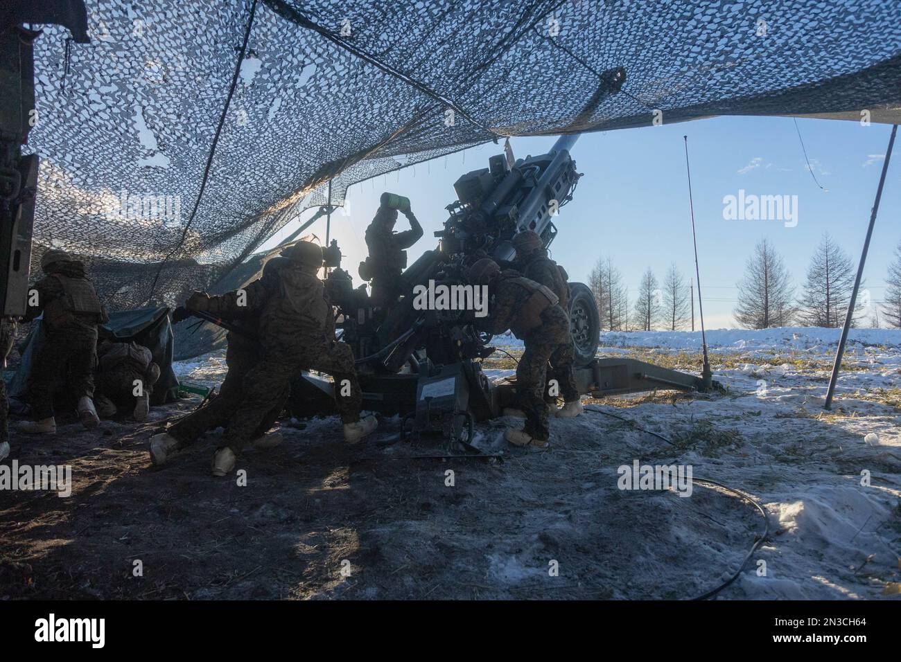 U.S. Marines with 3d Battalion, 12th Marines load a M777 towed 155 mm howitzer while conducting live-fire training during Artillery Relocation Training Program 22.4 at the Yausubetsu Maneuver Area, Hokkaido, Japan, Jan. 28, 2023. The skills developed at ARTP increase the proficiency and readiness of the only permanently forward-deployed artillery unit in the Marine Corps, enabling them to provide precision indirect fires. (U.S. Marine Corps photo by Lance Cpl. Jaylen Davis) Stock Photo