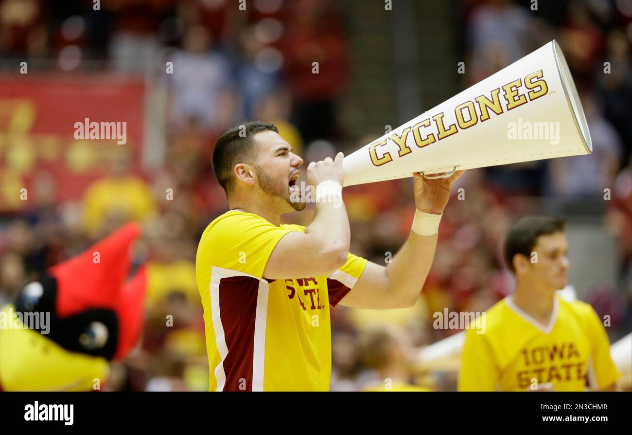 An Iowa State cheerleader shouts to fans before an NCAA college