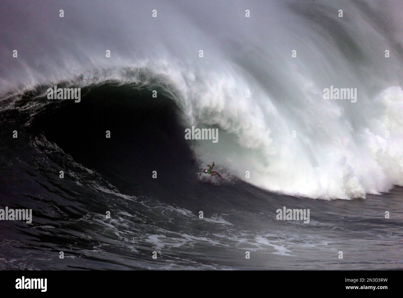 US surfer Garrett McNamara falls as he rides a big wave during a towin