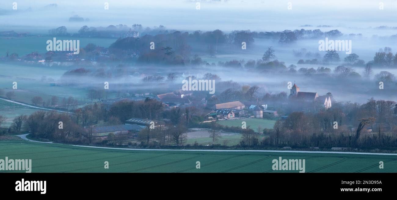 Morning mist snakes ghost-like through an isolated country village in the south of England; Lewes, East Sussex, England, United Kingdom Stock Photo