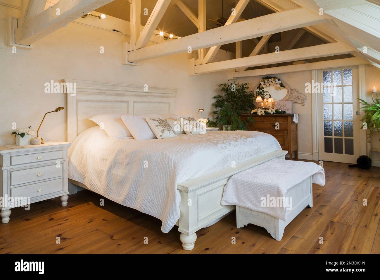 King size antique wooden bed in spacious master bedroom in attic inside ...