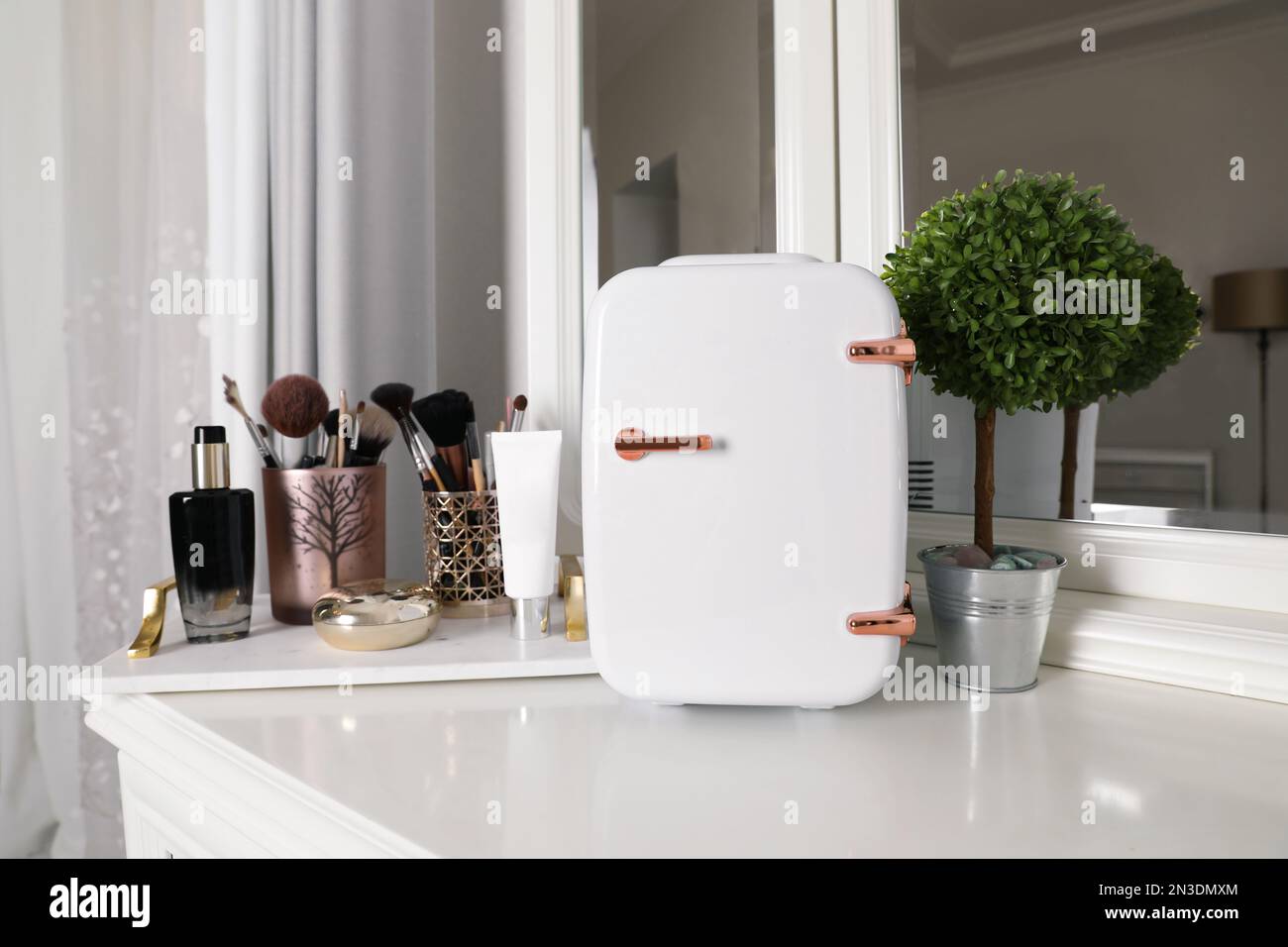 Mini fridge for cosmetic products on white vanity table Stock Photo Alamy