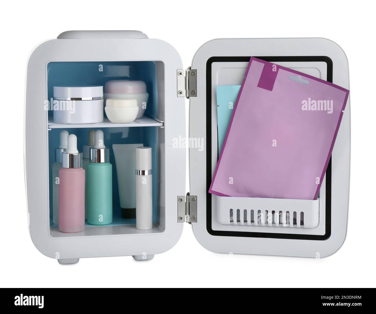 Cosmetics refrigerator with skin care products isolated on white Stock