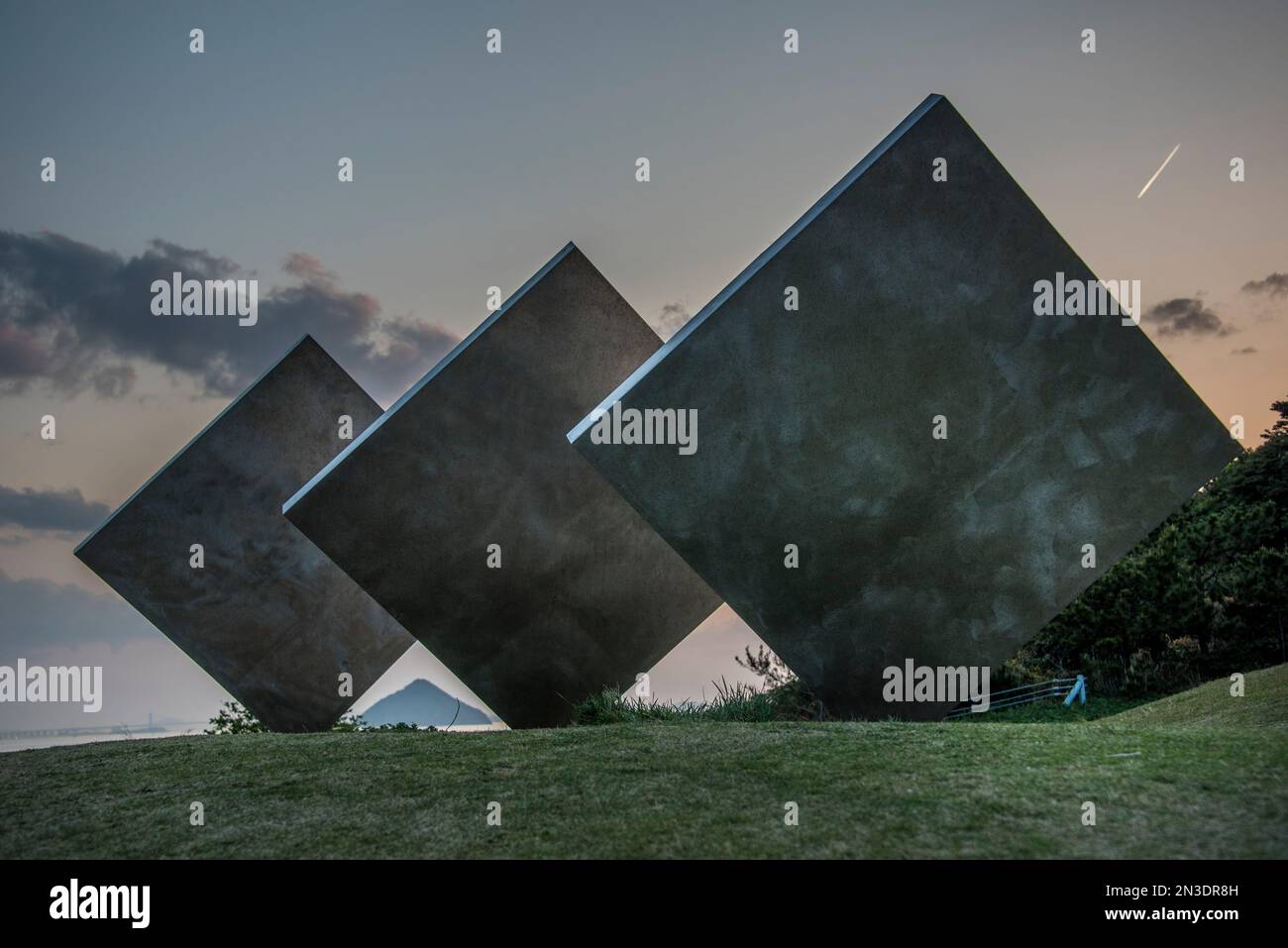 Modern sculpture, art installation of Three Vertical Squares Diagonal, balancing on their corners, standing in a field on Naoshima Island, an islan... Stock Photo