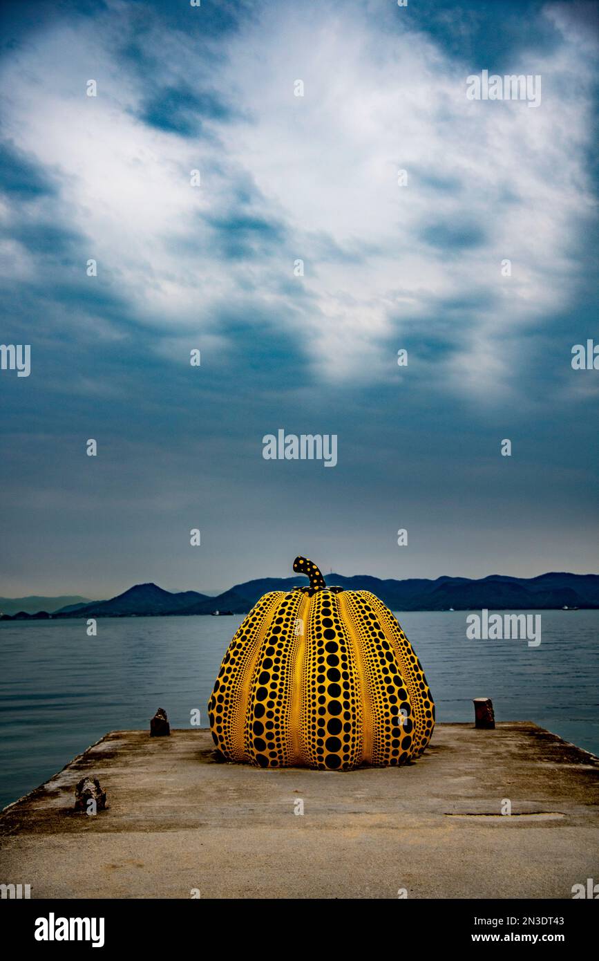 The Naoshima Pumpkin is a sculpture in the form of a giant black and yellow polka-dotted pumpkin by the celebrated artist Yayoi Kusama. It has stoo... Stock Photo