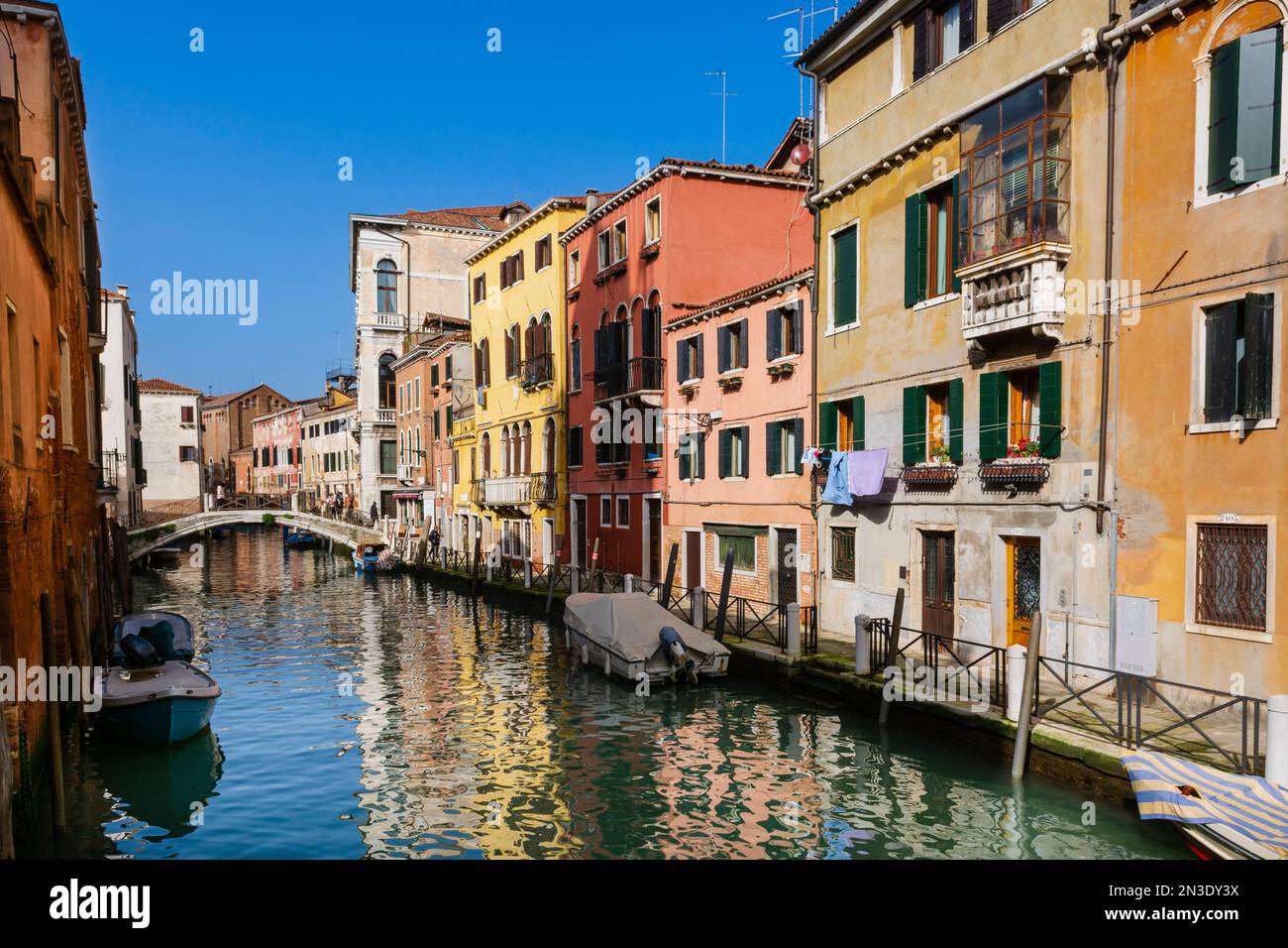 Typical buildings and canal life on a sunny day in Veneto; Venice Italy Stock Photo