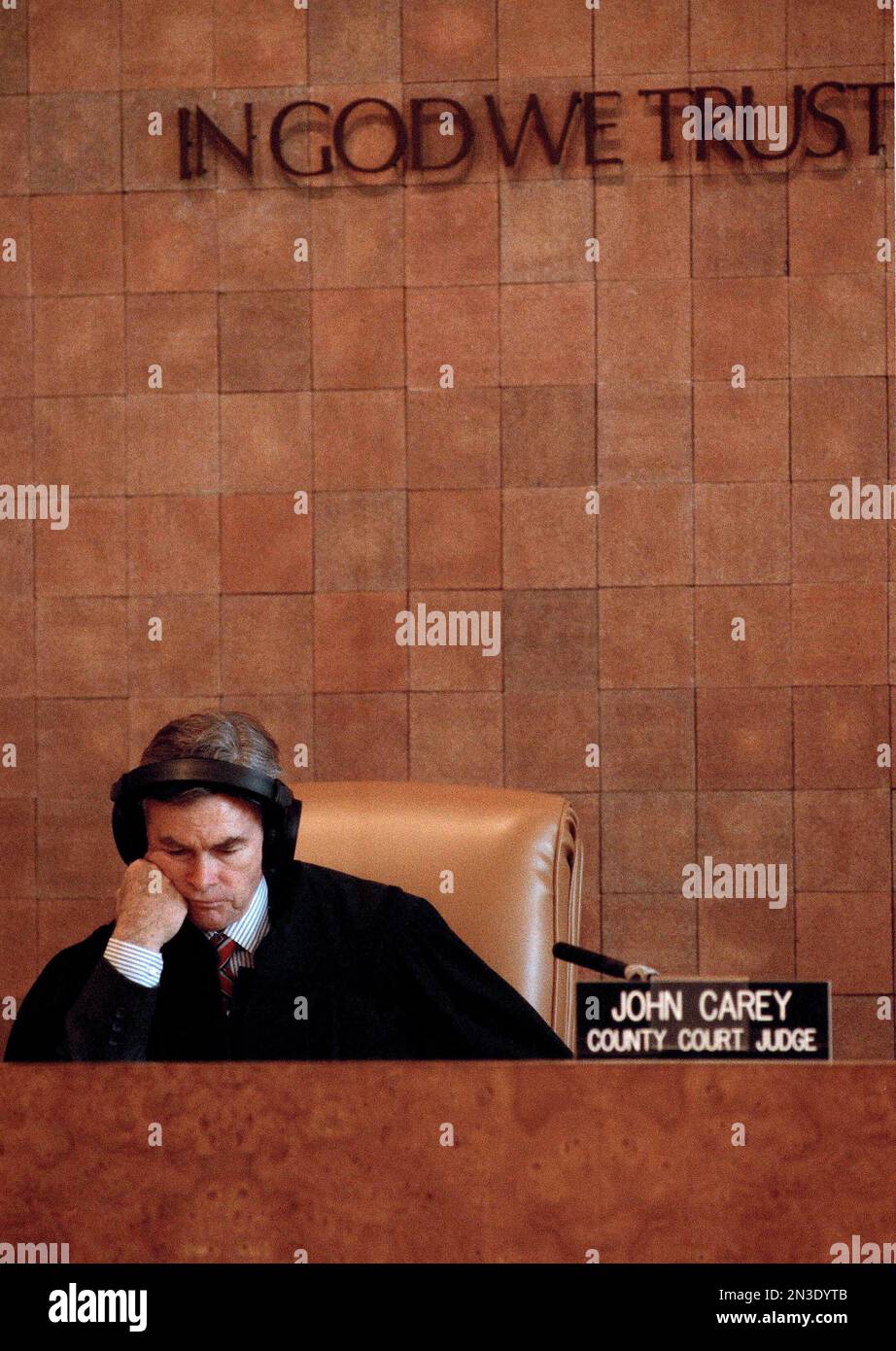 Judge John Carey listens to the recording of a police interview with