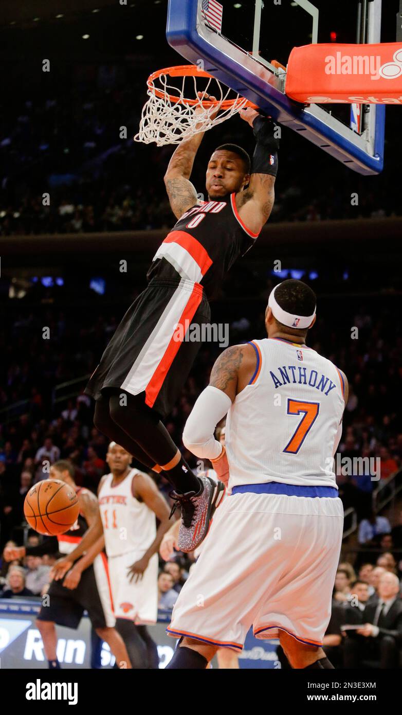 Portland Trail Blazers' Damian Lillard (0) dunks the ball in front of New  York Knicks' Carmelo Anthony (7) during the first half of an NBA basketball  game Sunday, Dec. 7, 2014, in, image size:782x1390