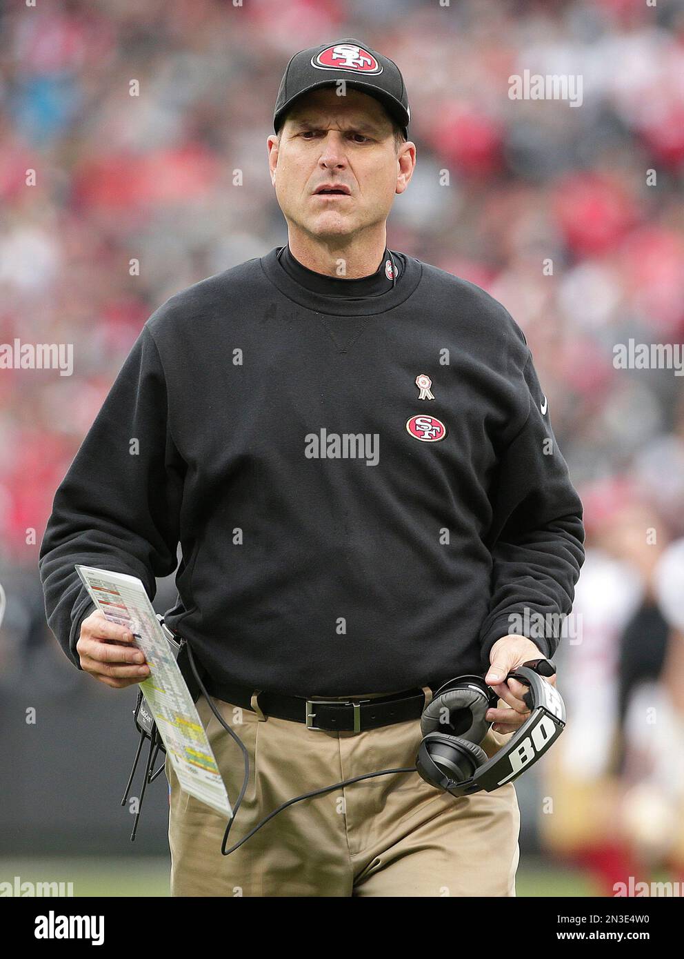 San Francisco 49ers head coach Jim Harbaugh walks on the field