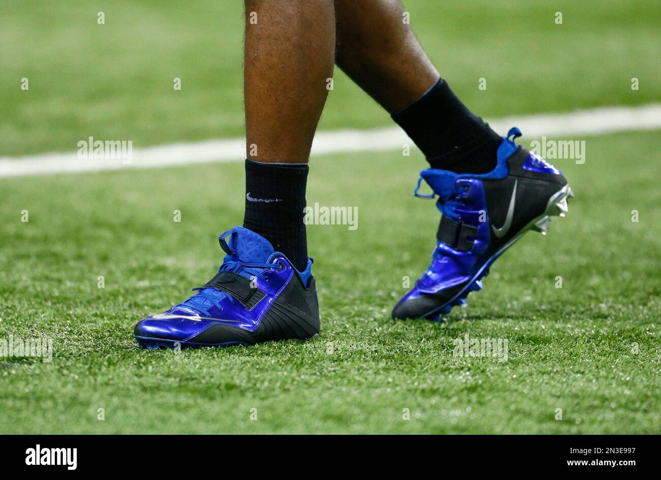 Detroit Lions wide receiver Calvin Johnson wears his blue Nike shoes during  pre-game warmups of an NFL football game against the Tampa Bay Buccaneers  in Detroit, Sunday, Dec. 7, 2014. (AP Photo/Rick