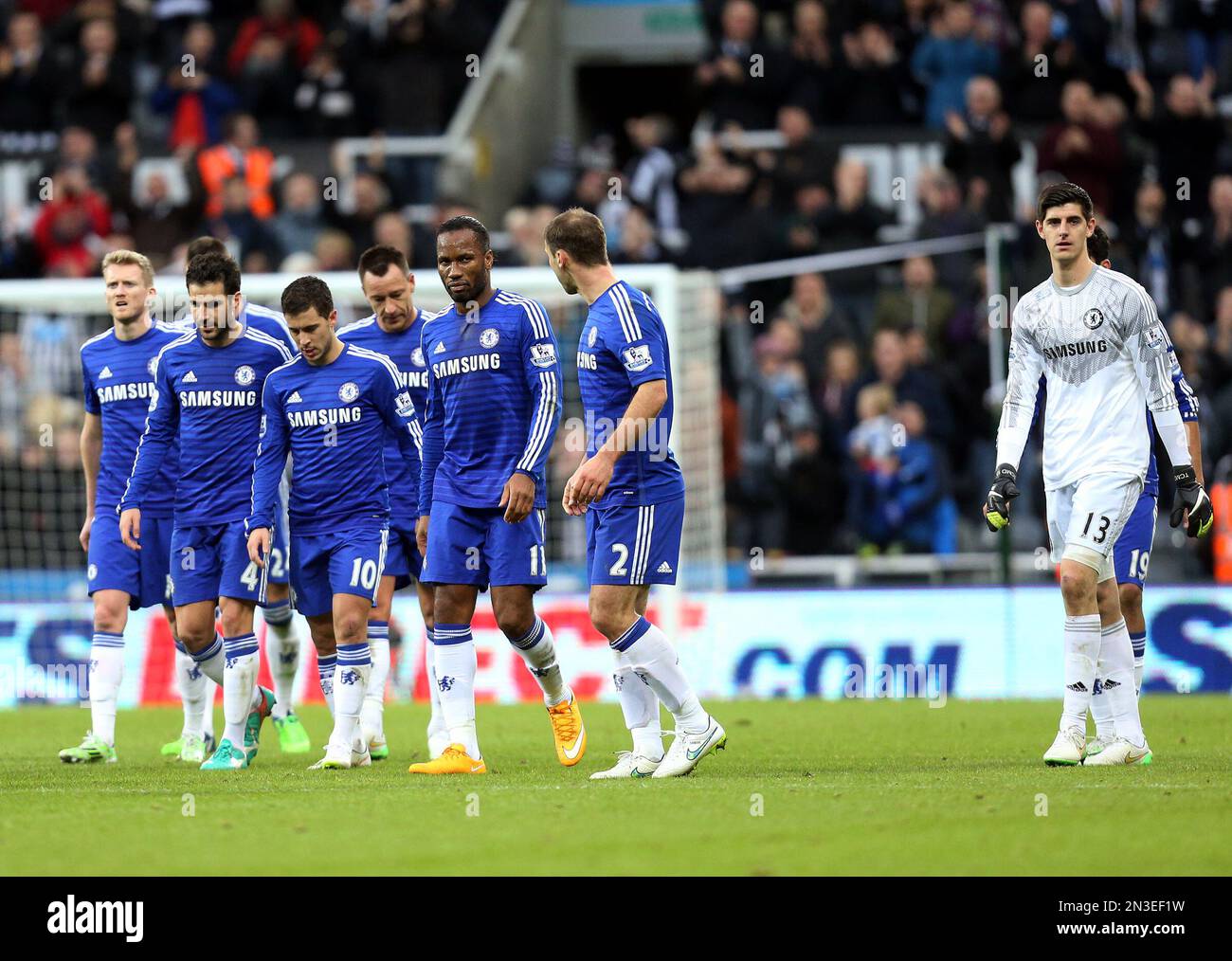 Chelsea players walk off the pitch after being defeated by Newcastle United at the end of their