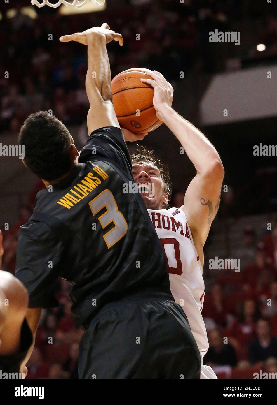 Oklahoma forward Ryan Spangler, right, shoots as Missouri forward