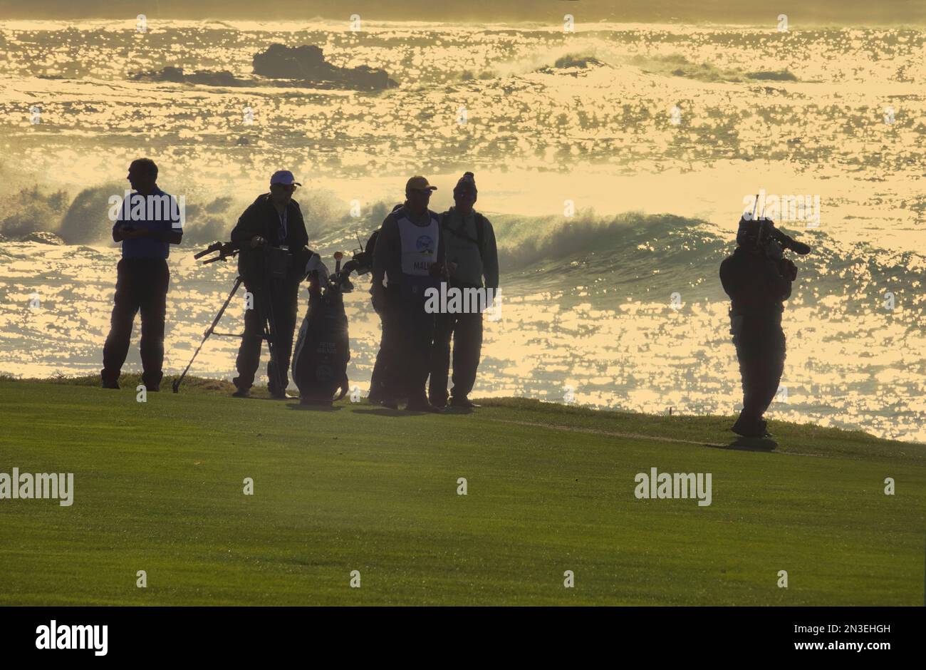 Pebble Beach, CA, USA. , . As the sun goes down caddies, players and TV