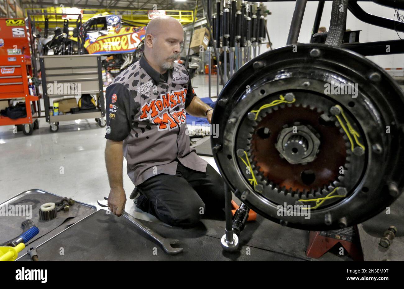John Sweeney works on the axle of a monster truck Tuesday, Nov. 25