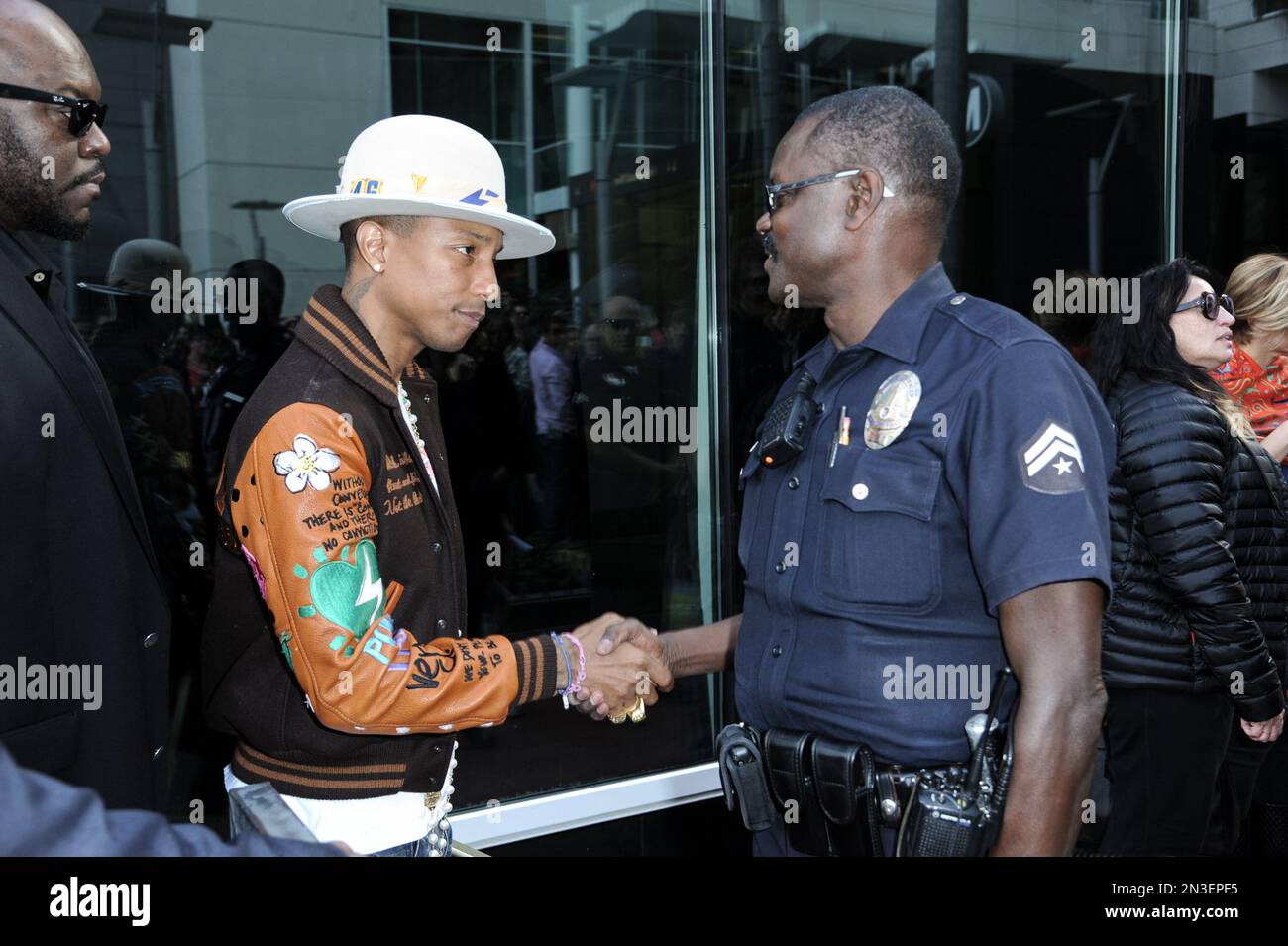 Pharrell Williams greets an LAPD officer after the ceremony honoring ...