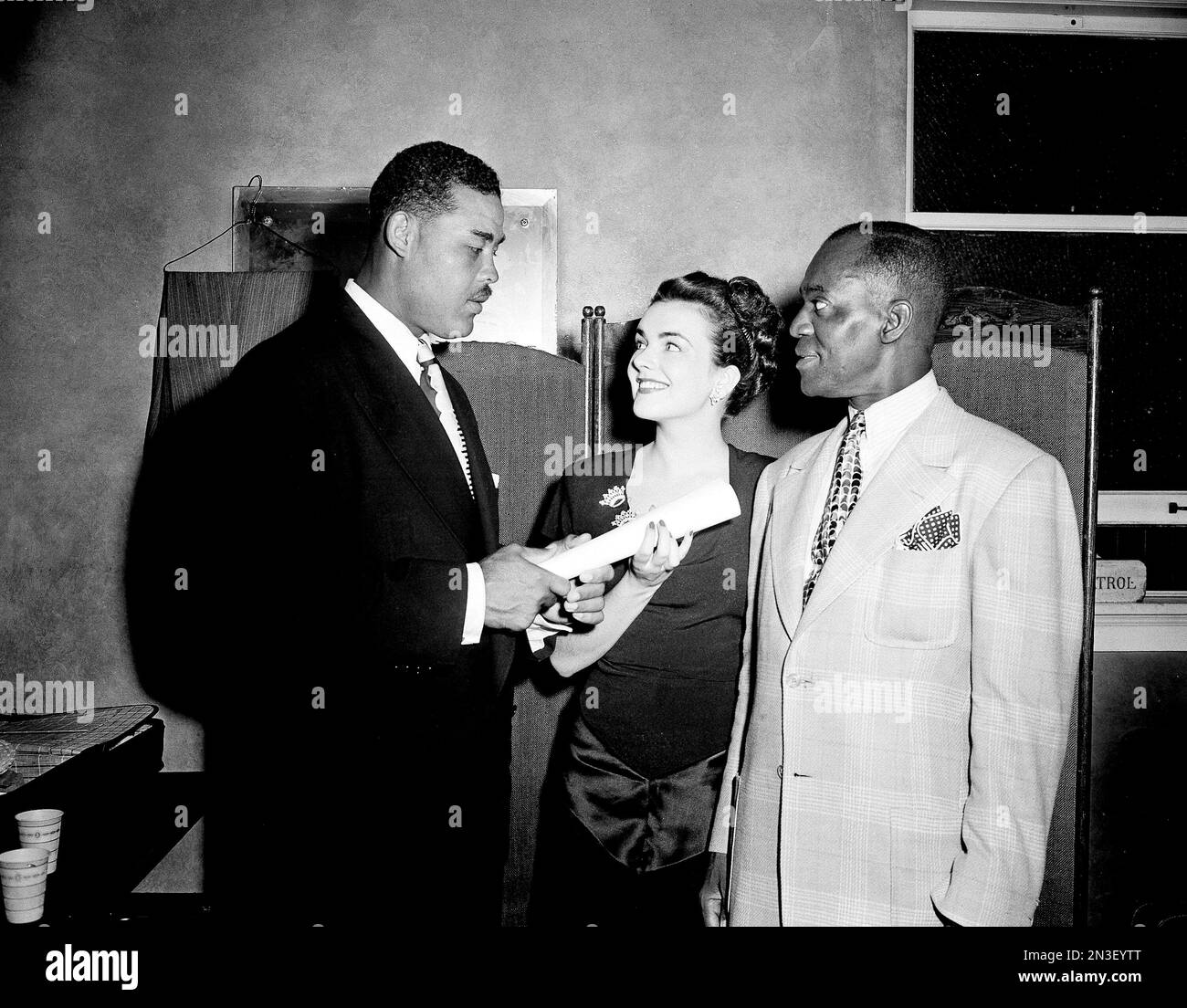 Heavyweight champion Joe Louis, left, gives a certificate of