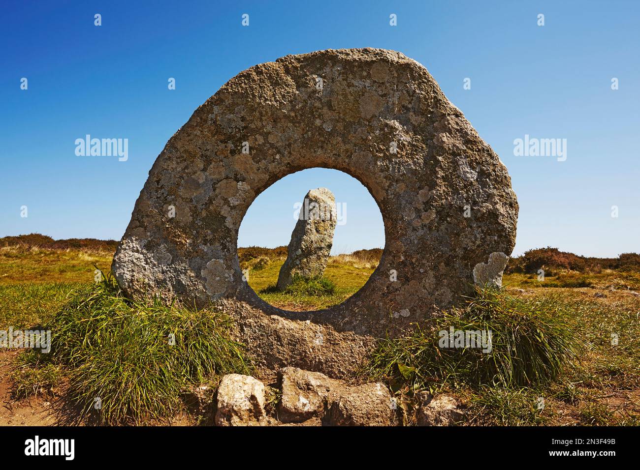 View through the holed stone of the prehistoric Men-an-Tol standing stones near Penzance; Cornwall, England, Great Britain Stock Photo