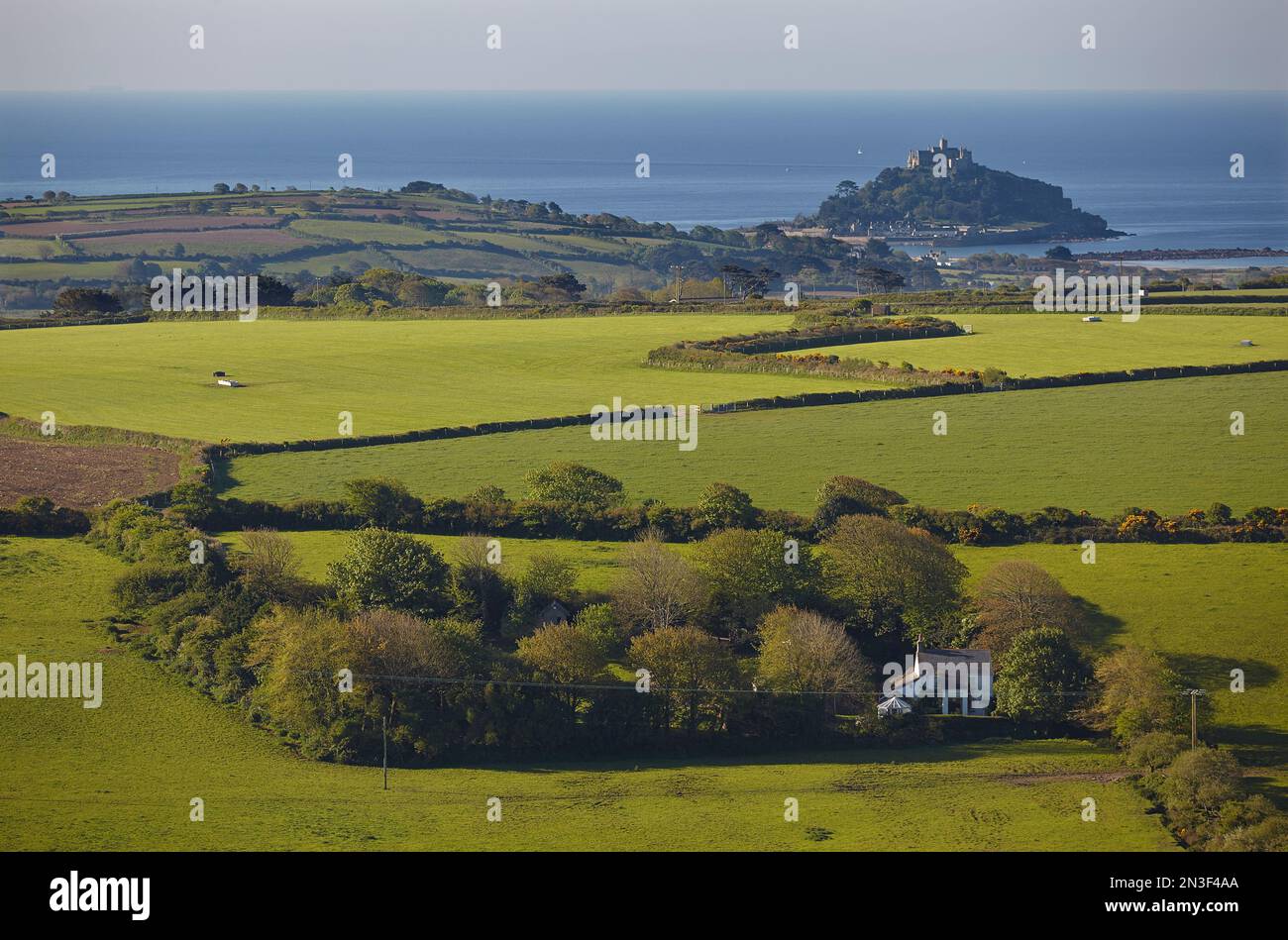 Green farmland and view of St Michael's Mount seen from Trencrom Hill