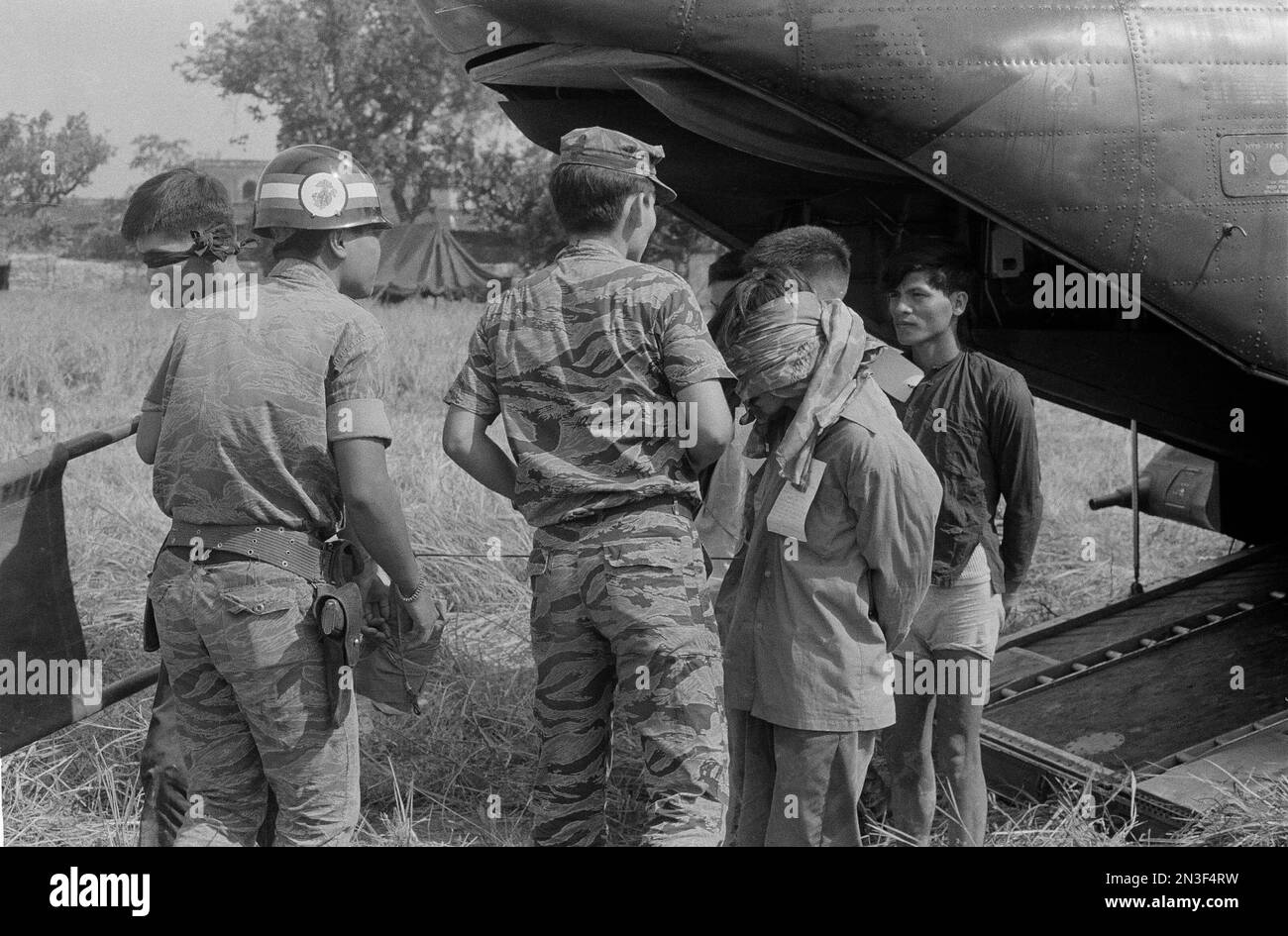 South Vietnamese marines in tiger-striped camouflage suits stand guard ...