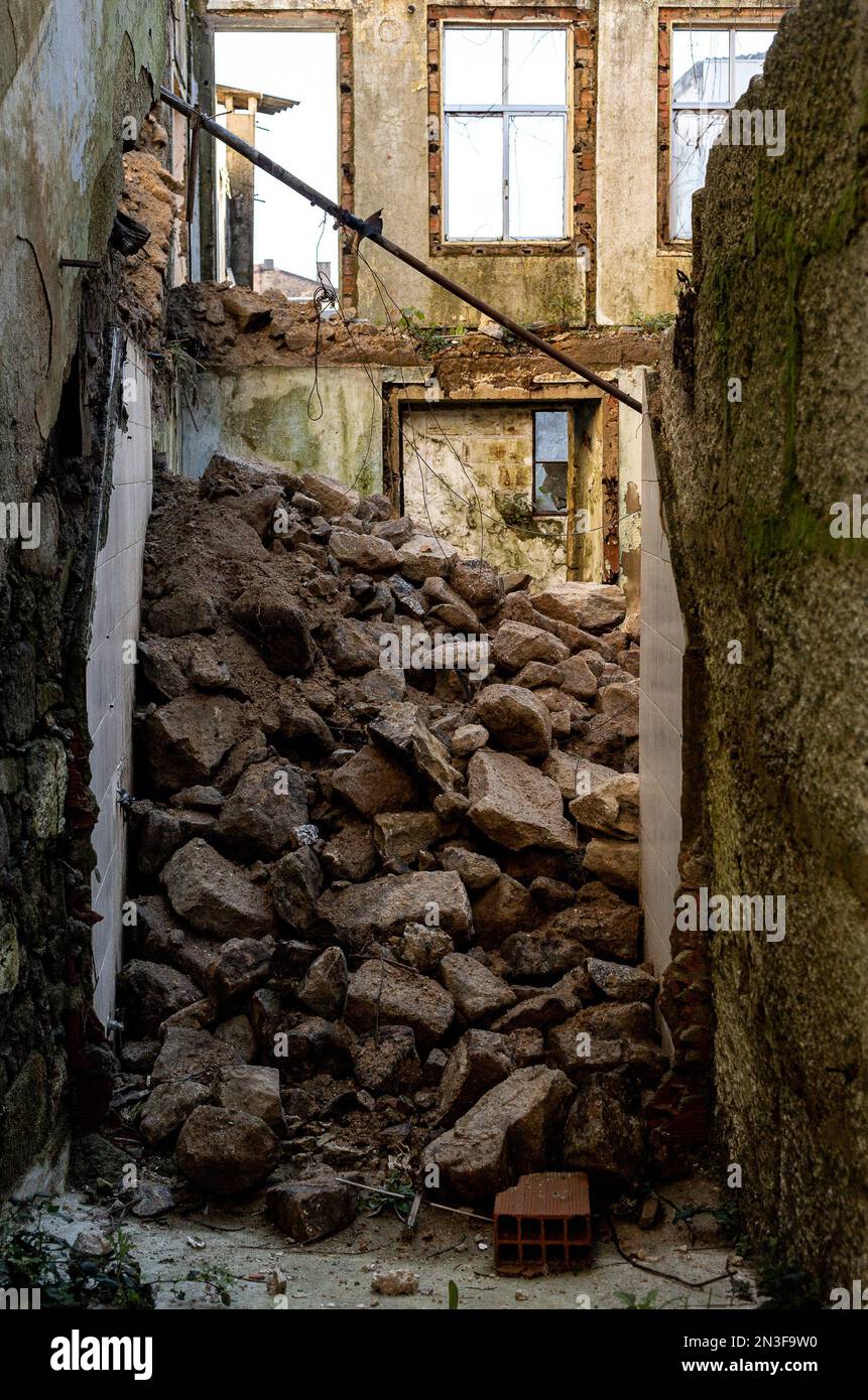 interior of a very old house in ruins with collapsed walls, rubble everywhere Stock Photo