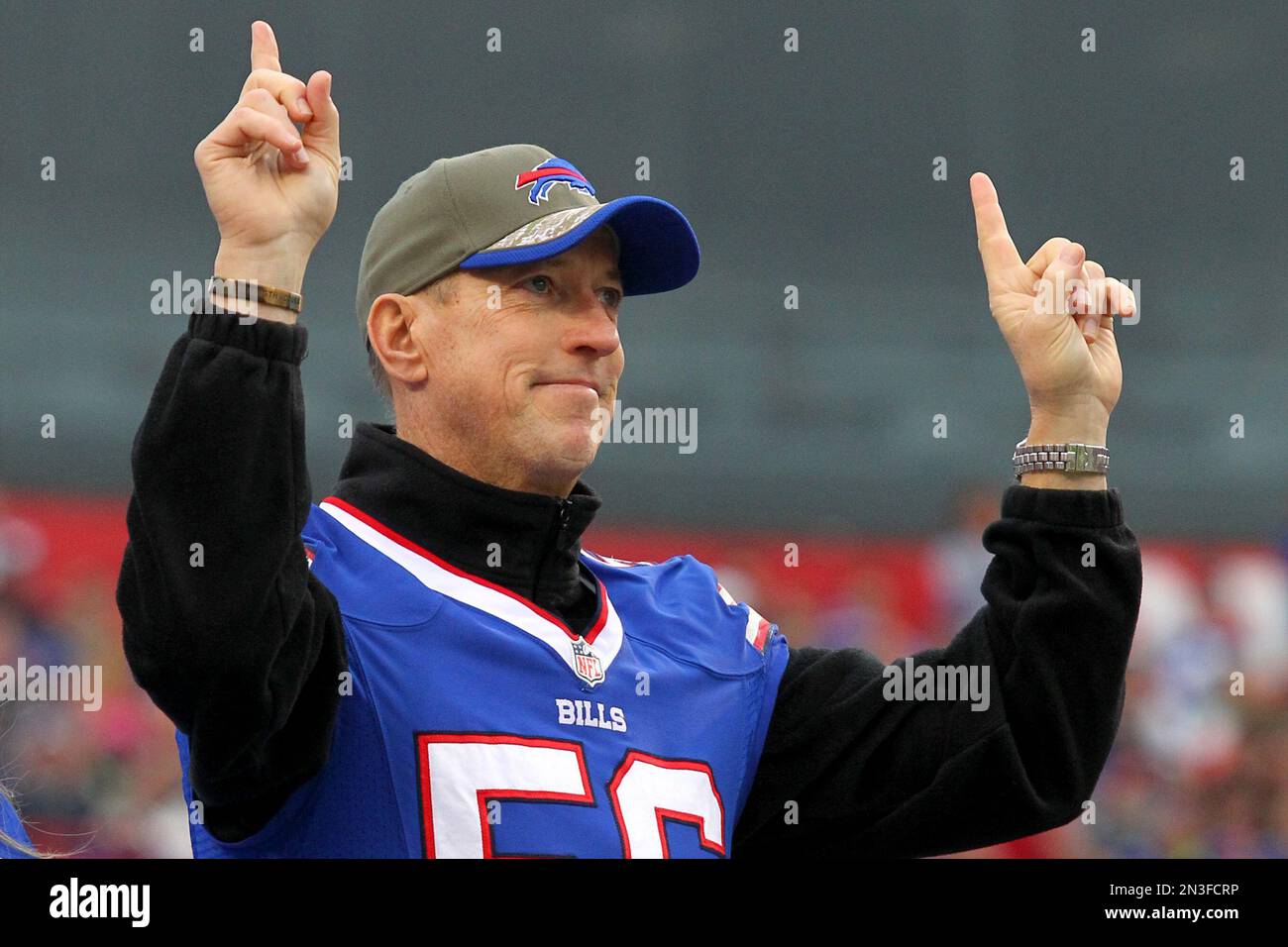 Buffalo Bills quarterback Jim Kelly, right, is greeted by Bills owner Ralph  Wilson, Jr. with a football and a jersey as he came off a private plane in  Buffalo, New York on