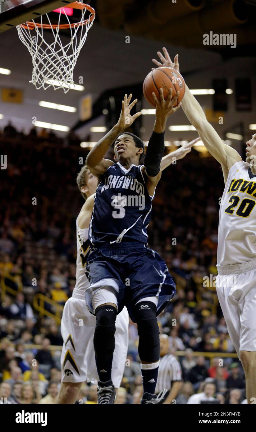 Longwood's Darrion Allen, center, goes to the basket between Iowa's