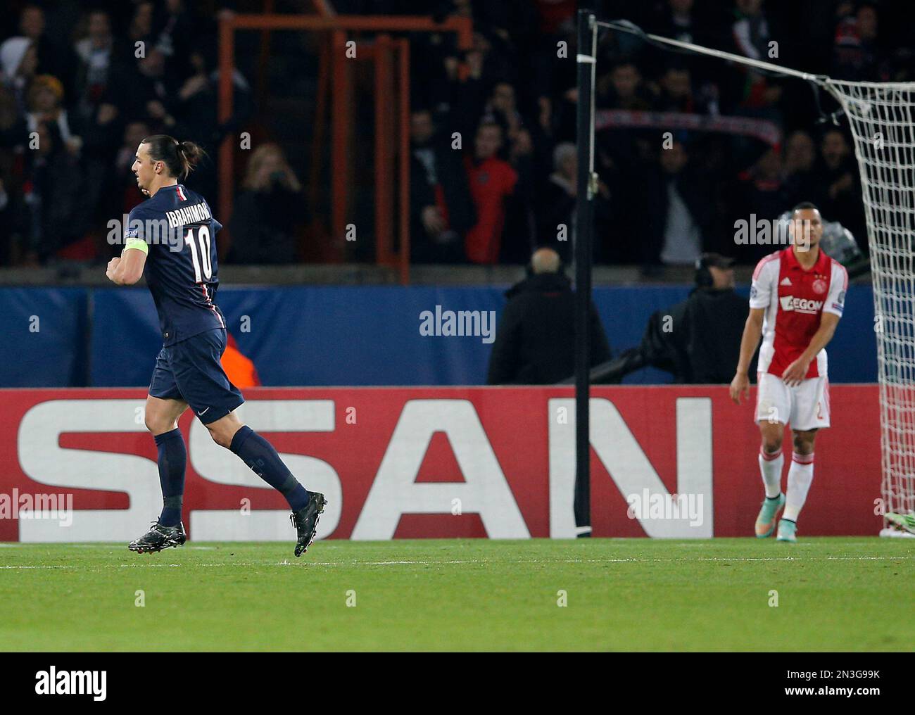 PSG's Zlatan Ibrahimovic, left, celebrates after scoring as Ajax's Ricardo  van Rhijn stands during the Champions League Group F soccer match between  Paris Saint Germain and Ajax at the Parc des Princes, image size:1300x1016