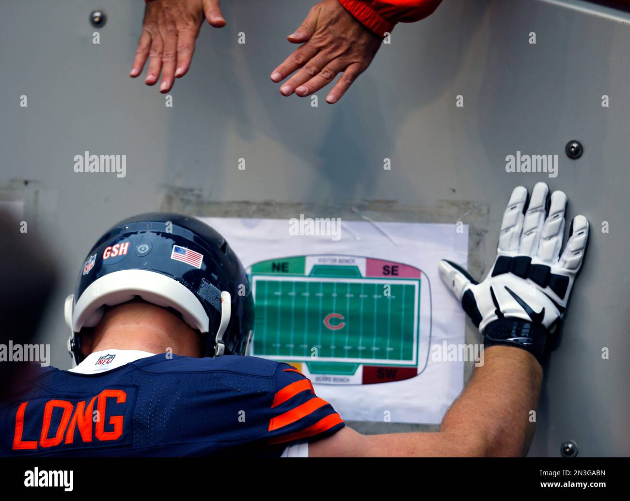 Chicago Bears offensive guard Kyle Long pulls off his gloves to give to  fans after the game against the Cincinnati Bengals at Soldier Field in  Chicago on September 8, 2013. The Bears