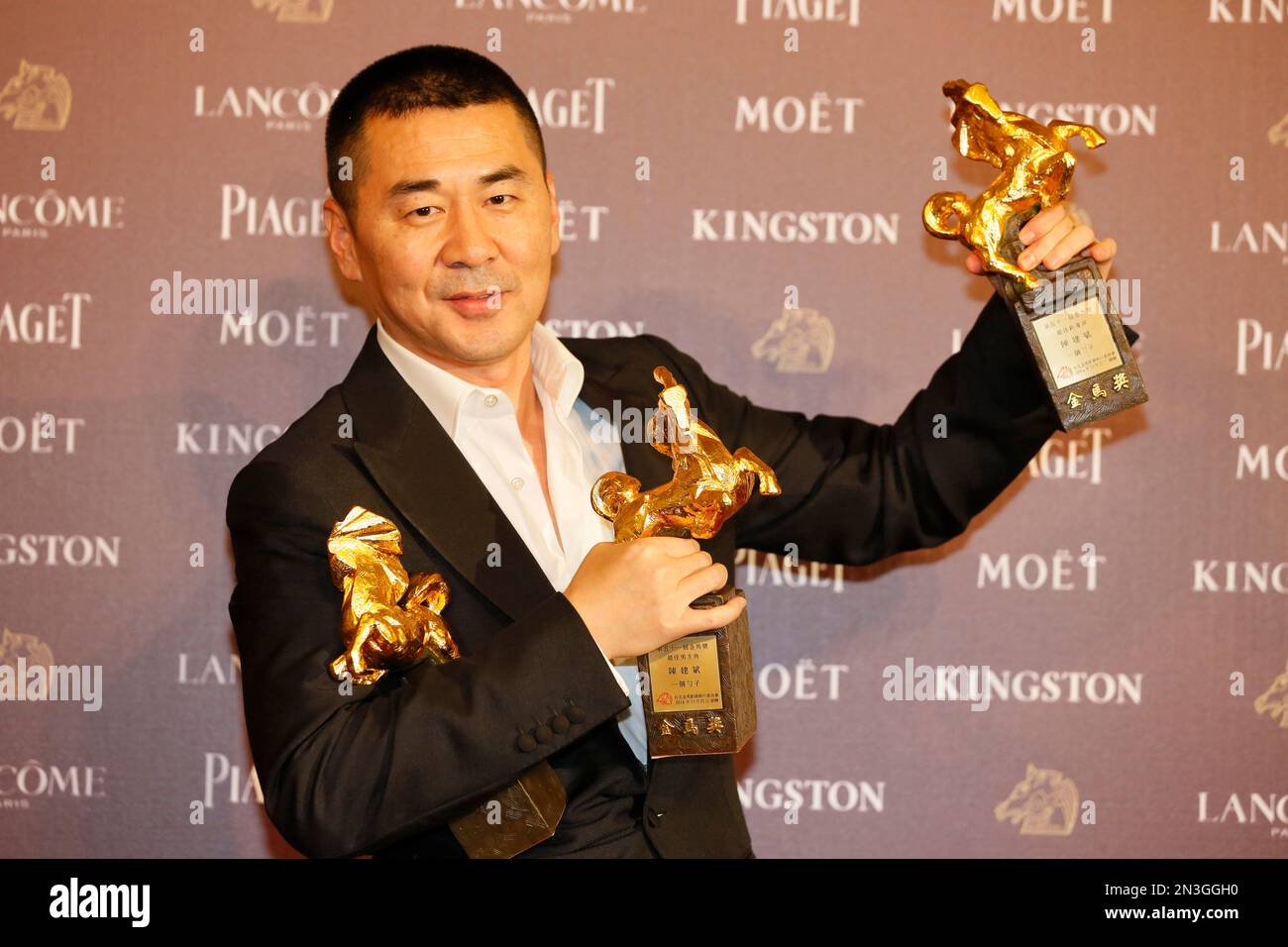 Chinese actor and director Chen Jianbin holds his awards for his films ...