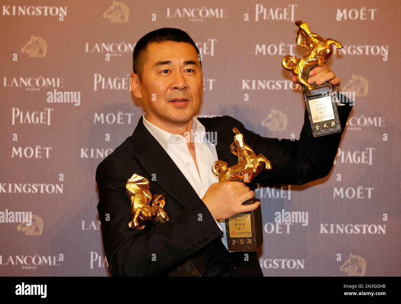Chinese actor and director Chen Jianbin holds his awards for his films ...