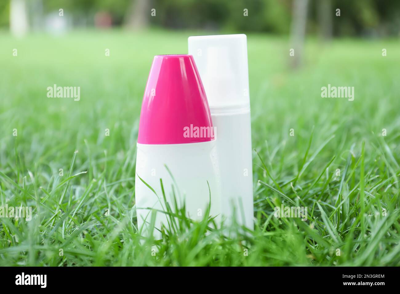 Bottles of insect repellent on green grass Stock Photo - Alamy