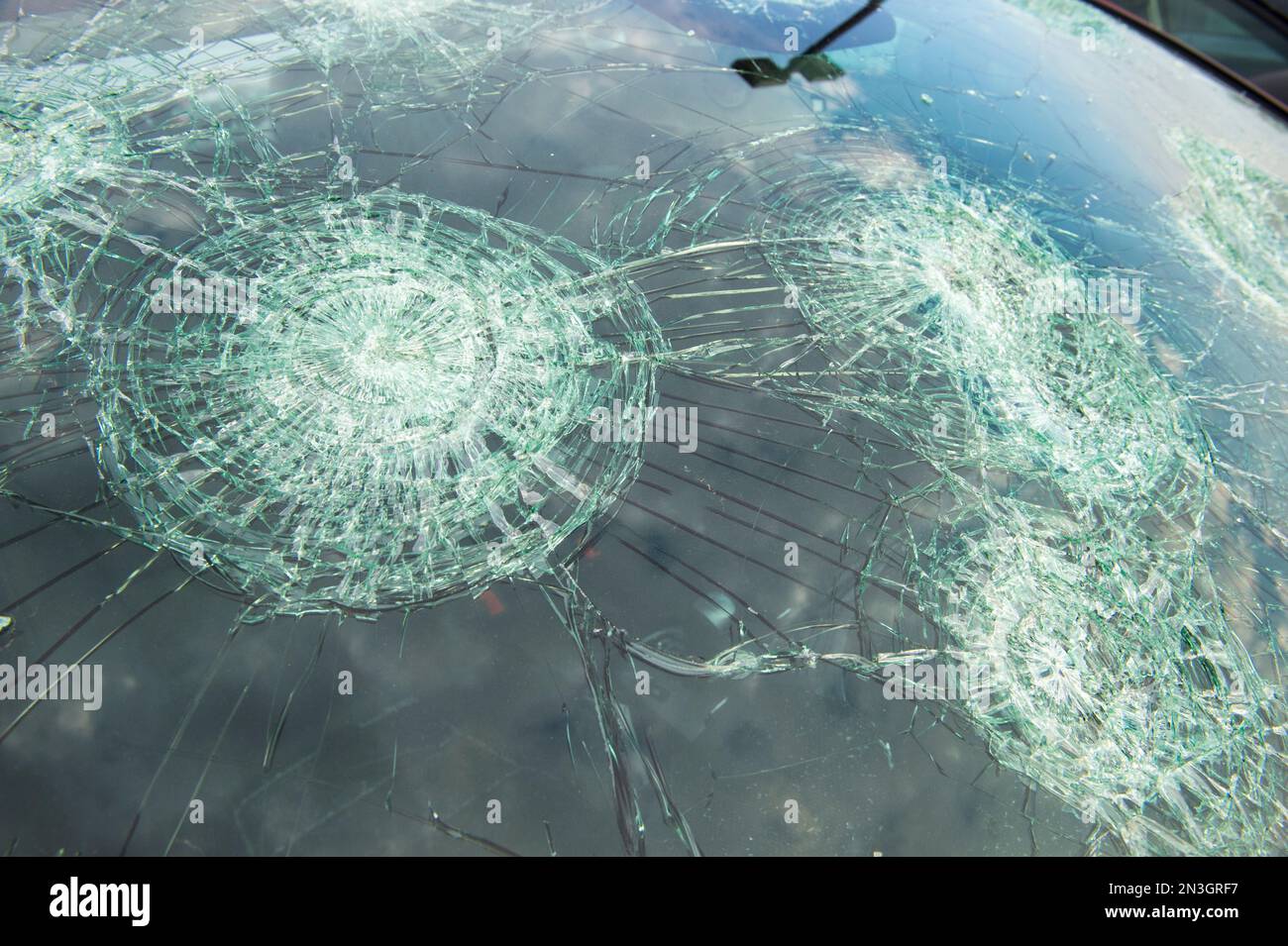 Severe hail damage on the windshield of a parked car; Blair, Nebraska, United States of America Stock Photo
