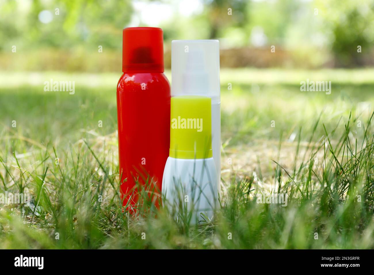 Bottles of insect repellent on green grass Stock Photo - Alamy