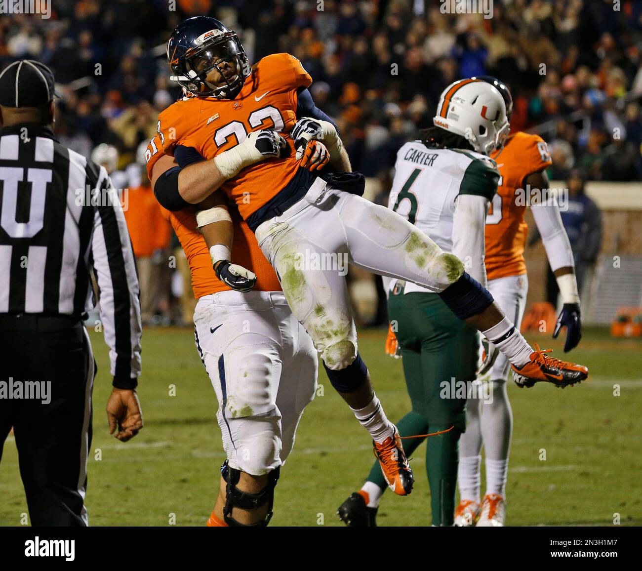 Virginia running back Khalek Shepherd (23) celebrates a touchdown with  teammate Virginia guard Cody Wallace during the second half of an NCAA  college football game against Miami in Charlottesville, Va., Saturday, Nov., image size:1300x1156