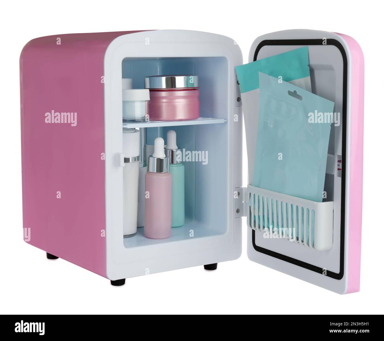 Pink cosmetics refrigerator with skin care products isolated on white