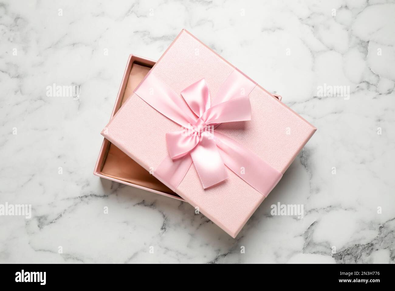 Beautiful pink gift box on white marble table, top view Stock Photo - Alamy