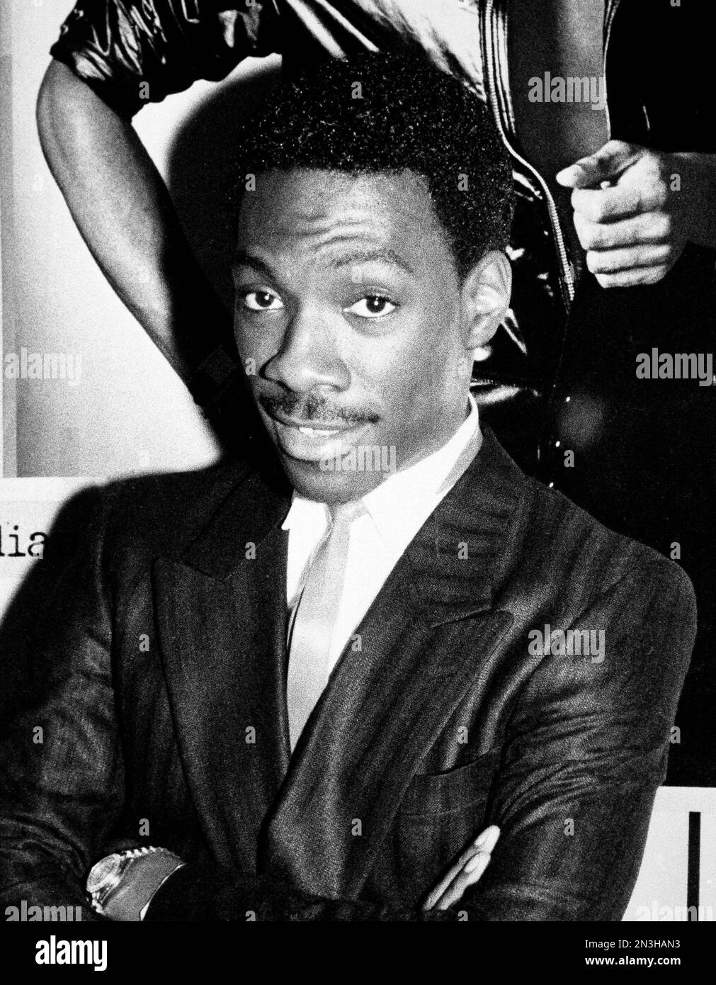 comedian-eddie-murphy-poses-in-front-of-a-poster-of-himself-at-a-crazy