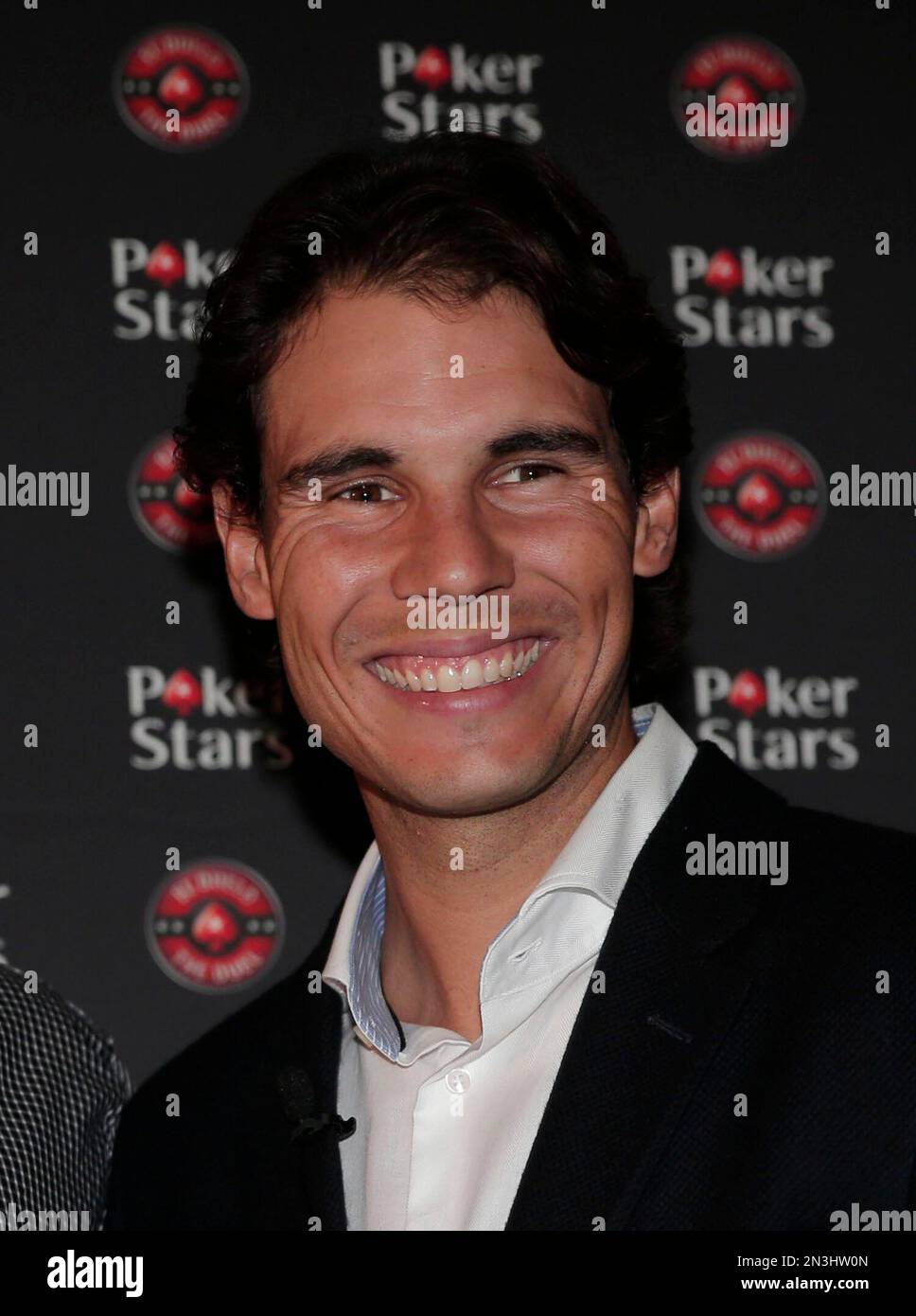 Tennis player Rafael Nadal, of Spain, poses for photographers prior to a charity poker match with Brazilian former soccer player Ronaldo at a casino in central London, Tuesday, Nov
