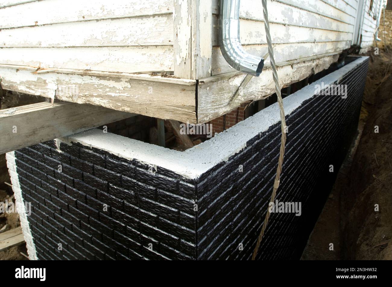 Black tar waterproofing on a newly-poured basement wall; Otoe, Nebraska, United States of America Stock Photo