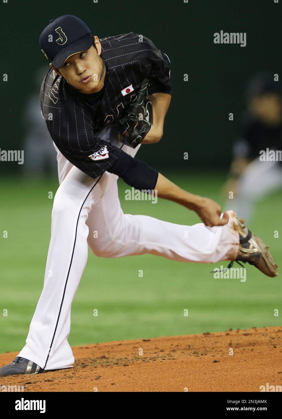 Japan's starter Shintaro Fujinami delivers a pitch against the MLB All ...