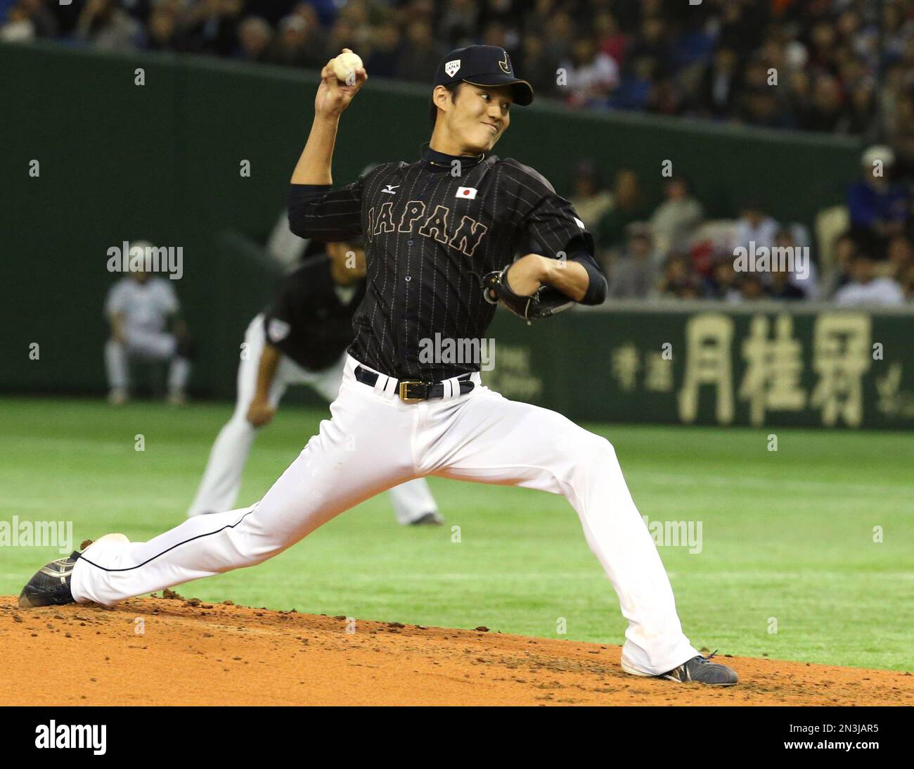 Japan's starter Shintaro Fujinami delivers a pitch against the MLB All ...